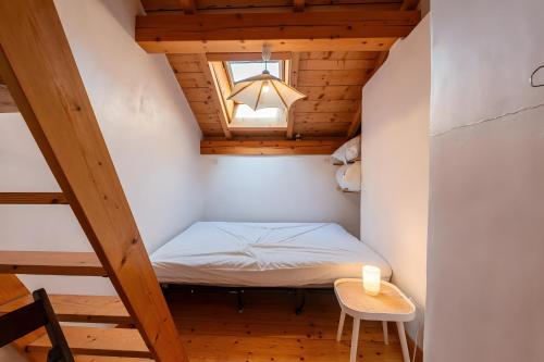 a small room with a bed and a table at Chambre d'hôte Chalet le Persan in Courchevel