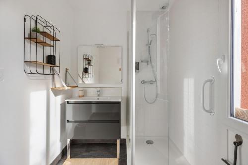 a bathroom with a sink and a shower at A L'orée D'angers - Terra Botanica in Avrillé
