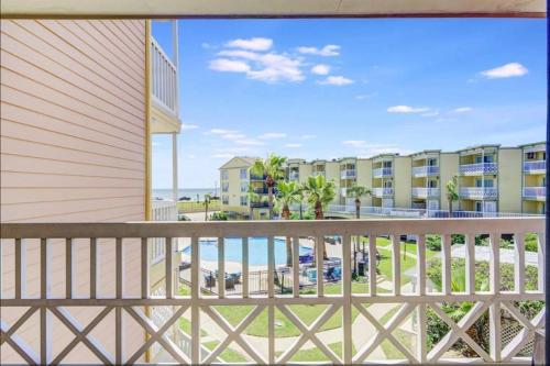 a balcony with a view of the beach and condos at Ocean & Pool View - Hot Tub - 2 Pools - Gym - Tennis ct - Shoreline Stays 10 in Galveston