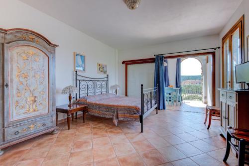 a bedroom with a bed and a large window at Appartamenti Castle in Campo nell'Elba