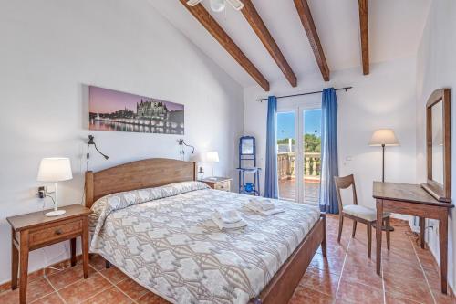 a bedroom with a bed and a desk at Villa Paula in Sa Ràpita