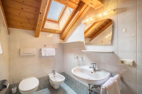a bathroom with a sink and a toilet at Oberhölzlhof in Valdaora di Sopra