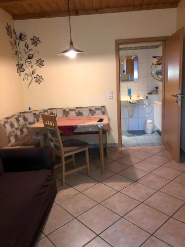 a dining room with a table and a couch at Ferienwohnung Stark in Scheßlitz