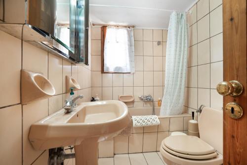 a small bathroom with a sink and a toilet at Villa Sugar Town in Zacharo