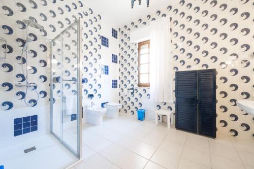 a bathroom with a shower and a toilet and a sink at Il Faro in Sarroch