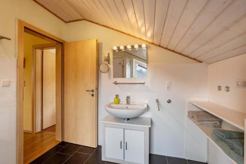a bathroom with a sink and a mirror at Ferienwohnung 'Sonneck' in Eckernförde