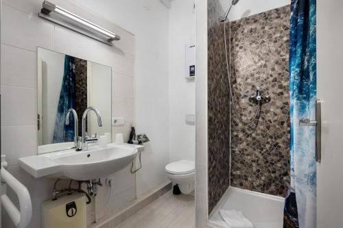 a bathroom with a sink and a toilet and a shower at Gruppenhaus Osterhagen in Bad Lauterberg