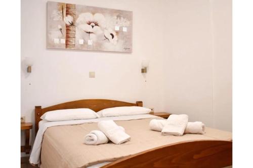a bedroom with a bed with towels on it at Manolika Studio 1 in Kithnos