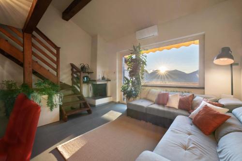 a living room with a couch and a window at Lake Como - Incanto in Valvarrone