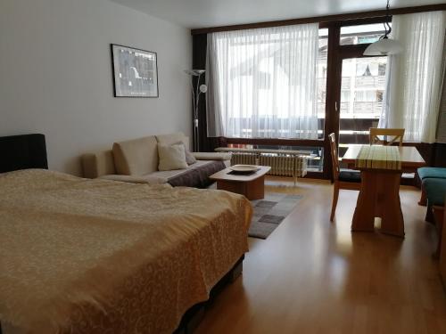 a living room with a bed and a couch at Schloss Grubhof Appartement in Sankt Martin bei Lofer
