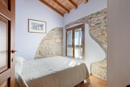 a bedroom with a bed and a window at Villa Gardenia - Private Garden in Sarzana