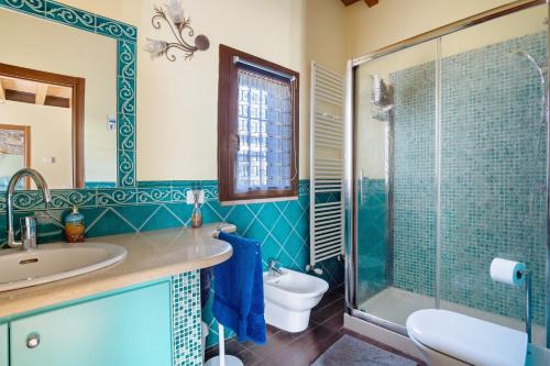 a bathroom with a sink and a toilet and a shower at Villa Gardenia - Private Garden in Sarzana