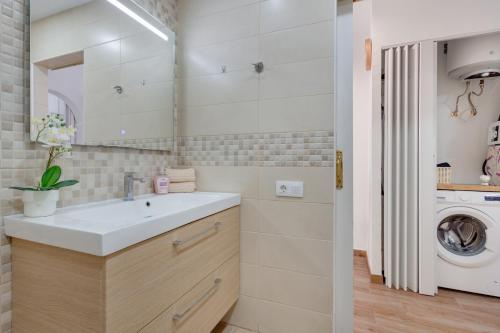 a bathroom with a sink and a washing machine at Casa Lotti With Ocean View in Santa Cruz de Tenerife