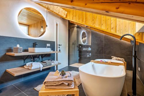 a bathroom with a large tub and a sink at Casa Facco in Bocenago