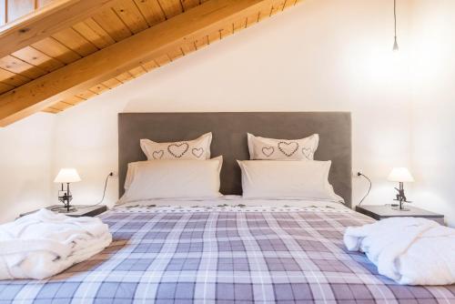 a bedroom with a bed with a plaid bedspread at Casa Facco in Bocenago