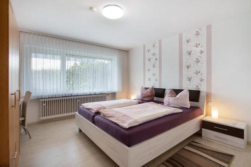 a bedroom with a bed and a window at Ferienwohnung Barbara in Karsau