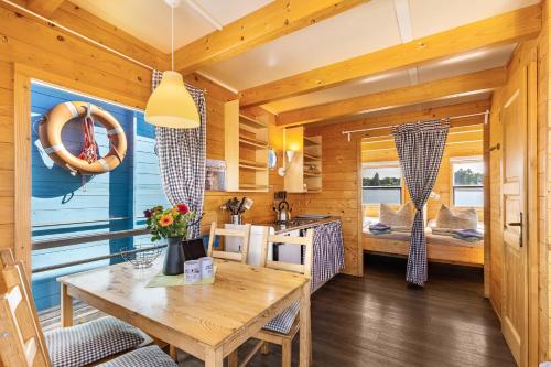 a kitchen and dining room with a table and chairs at Marina Zernsdorf in Zernsdorf