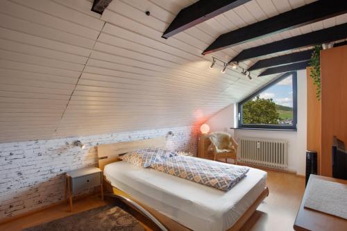 a bedroom with a bed in a room with a window at Ferienwohnung Lux in Plettenberg