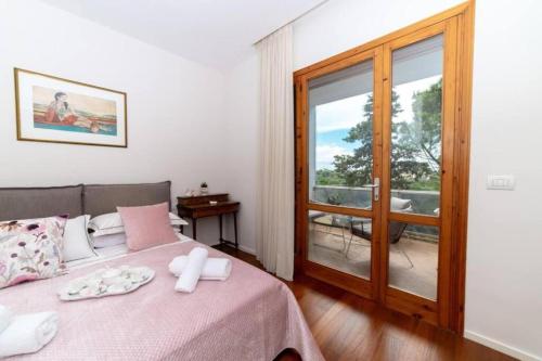 a bedroom with a bed and a balcony with a view at La Dimora del Benessere in Noicattaro