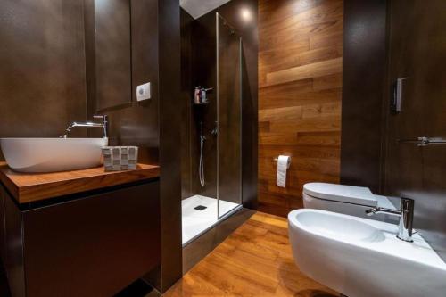 a bathroom with a sink and a shower and a toilet at La Dimora del Benessere in Noicattaro