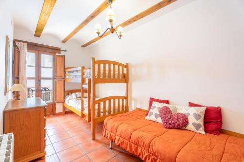 a bedroom with a bed and a bunk bed at Cueva De La Portería in Chulilla