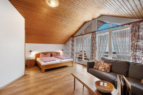 a living room with a couch and a bed at Josenhof in Wolfach