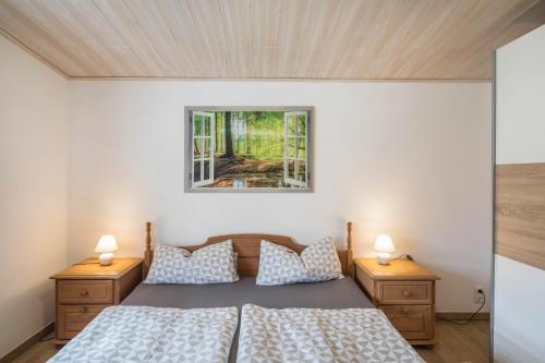 a bedroom with a bed and two night stands at Ferienhaus Bornwiese in Schwalmtal