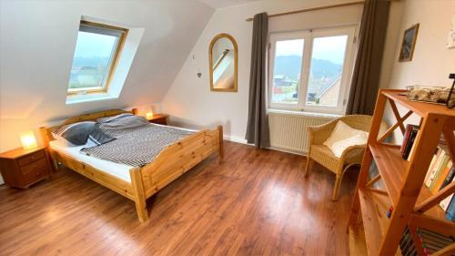 a bedroom with a bed and two windows at Ferienwohnung Schmilau in Schmilau