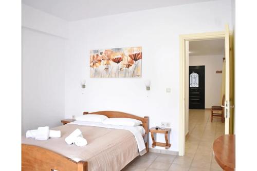 a bedroom with a bed and a painting on the wall at Manolika Studio 6 in Kithnos