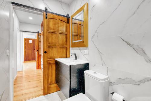 a bathroom with a sink and a toilet at Kuko Beach Denia in Denia