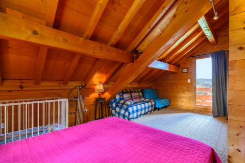 a bedroom with a bed and a couch in a room at Chalet Du Wason in Xonrupt-Longemer