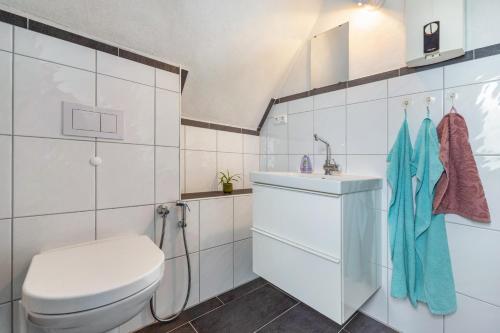 a white bathroom with a toilet and a sink at Bad day good day in Horn-Bad Meinberg