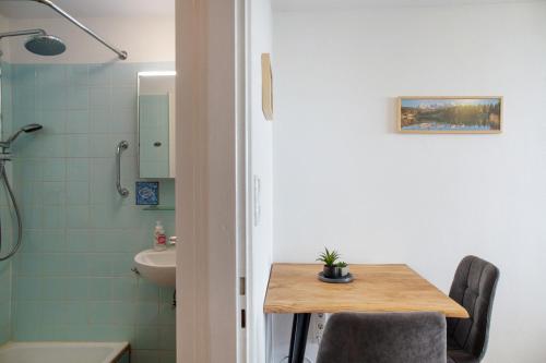a bathroom with a table and a sink and a shower at Apartment Biendl in Mittenwald