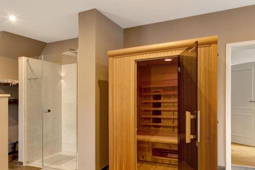 a bathroom with a glass shower and a glass door at Vierseitenhof mit Pool in Ziesar