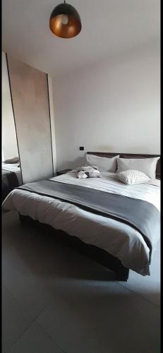 a bedroom with a large bed with white sheets at attico19 in Montecatini Terme