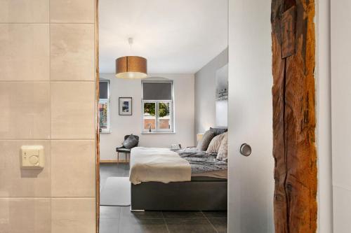 a bedroom with a bed and a mirror at Schöne Altstadtwohnung In Neuruppin in Neuruppin