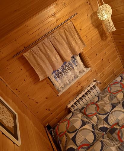 an attic room with a bed and a window at Domek nad Lasem in Koniaków