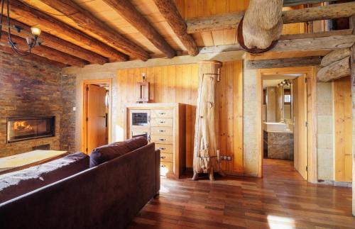 a living room with a couch and wooden walls at Can Ricart in Puigcerdà