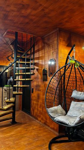 a room with a spiral staircase in a house at Nakas cottage in Tbilisi City