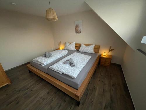 a bedroom with a large bed with two pillows at Haus Jakob in Longkamp
