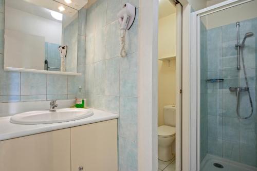 a bathroom with a sink and a shower at Le Mas Berliat N°7 in Bormes-les-Mimosas