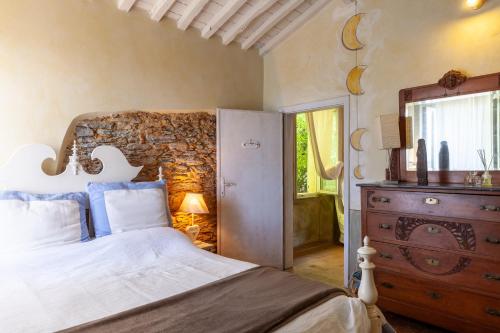 a bedroom with a bed and a dresser and a mirror at Il Pescino in Pietrasanta