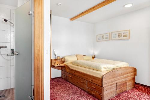 a bedroom with a bed and a shower at Gästehaus Krone in Sankt Georgen im Schwarzwald