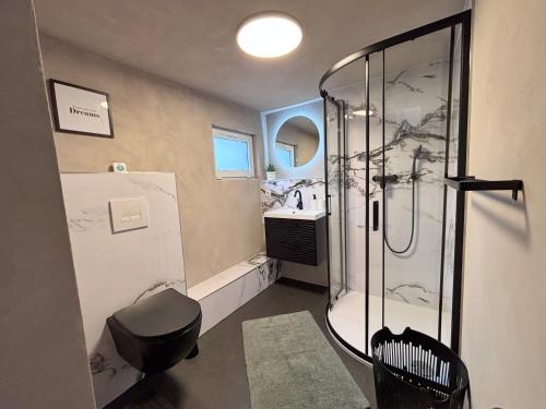 a bathroom with a shower and a sink at Casa Kokorey in Rellingen