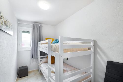 a bedroom with two bunk beds in a room at Cal Jaume in Masquefa