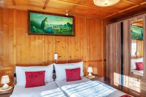 a bedroom with a bed with a painting on the wall at Ferienhaus Wechner in Häselgehr