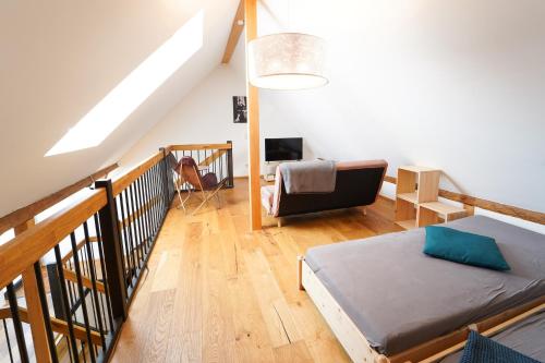 a bedroom with a bed and a couch in a room at Wendlingen Ferienwohnung 3 in Freiburg im Breisgau