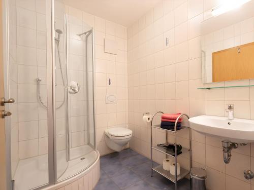 a bathroom with a shower toilet and a sink at Ferienhof Bosch in Börslingen