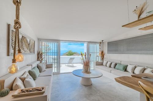 a living room with a couch and a table at Oceania Villa A in Chayofa