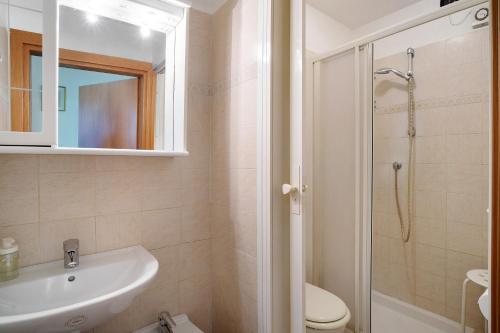 a bathroom with a sink and a toilet and a shower at Monolocale La Pineta 46 in Albenga